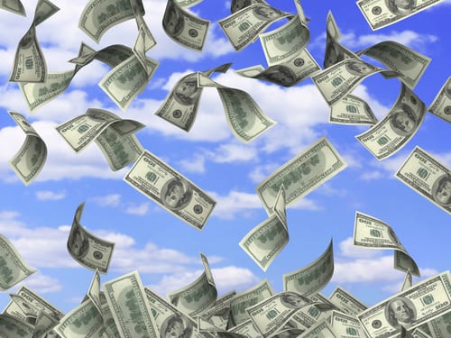 Hundred-dollar bills falling through a blue sky