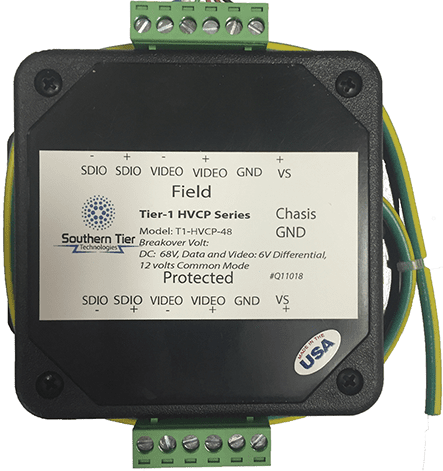 A Southern Tier Technologies Tier-1 HVCP signal surge protector — a small black module with green terminal blocks at top and bottom and a rating label on its face